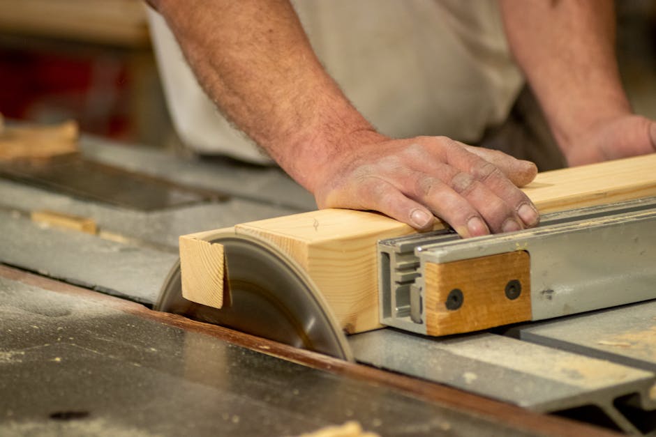 Carpenter meticulously crafting wood kitchen cabinets in a workshop