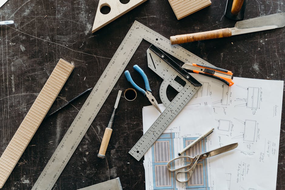 Woodworking tools and architectural kitchen plans on a desk